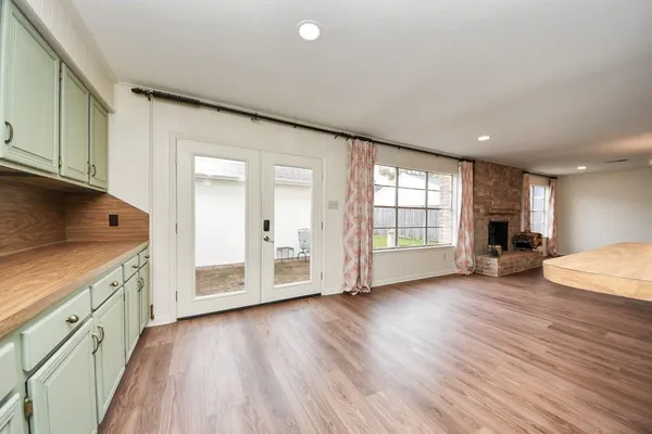 a view of a kitchen with wooden floor and a sink