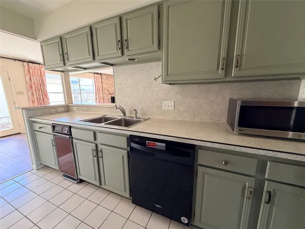a kitchen with stainless steel appliances granite countertop a sink stove and microwave