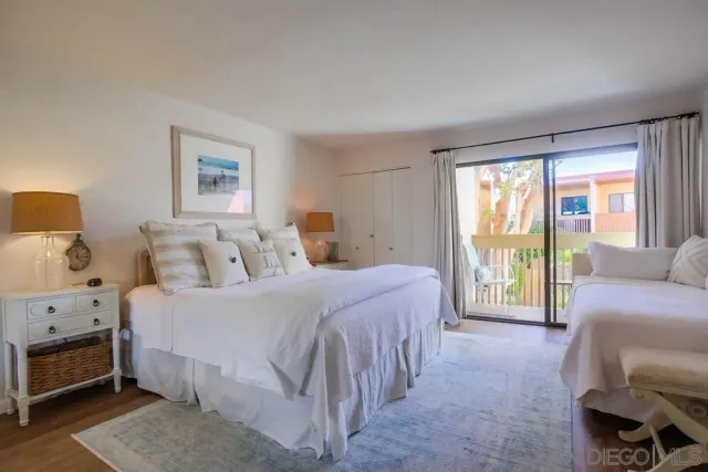 a spacious bedroom with a bed and a couch