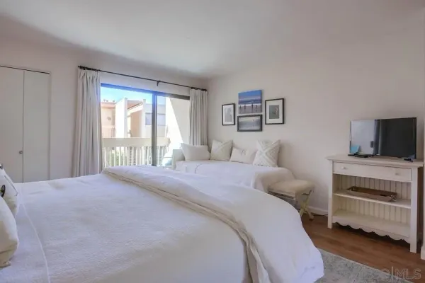 a bedroom with a bed and a television