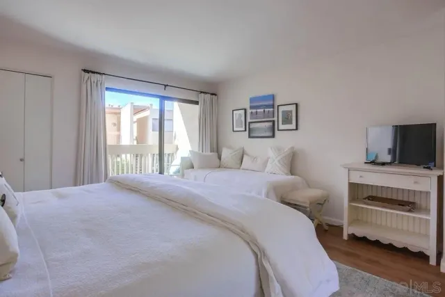 a bedroom with a bed and a television