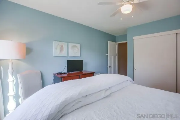 a bedroom with bed and a night stand