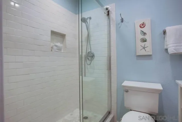 a bathroom with a toilet and a shower