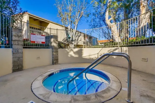 a view of house with swimming pool outdoor seating