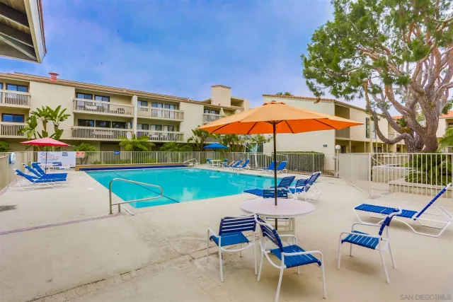 a view of a swimming pool with chairs in patio