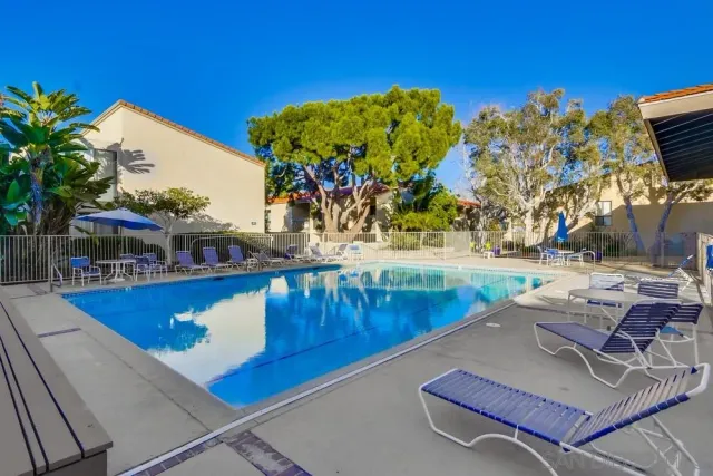 a view of a tennis ground with large trees