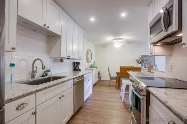 a kitchen with cabinets and stainless steel appliances