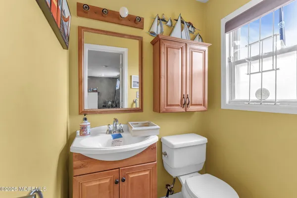 a bathroom with a toilet sink and mirror
