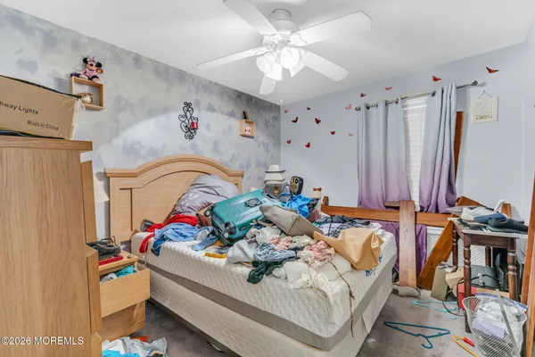 a bedroom with furniture and a chandelier