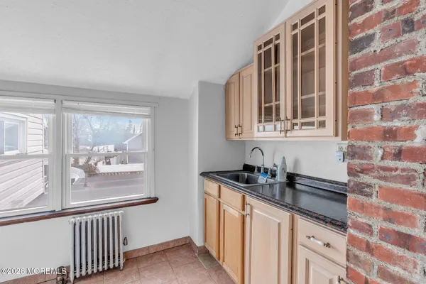 a kitchen with granite countertop a sink and a window