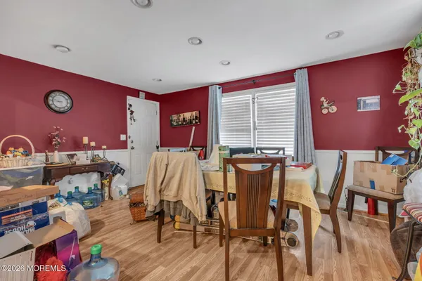 a very nice looking dining room with furniture and wooden floor