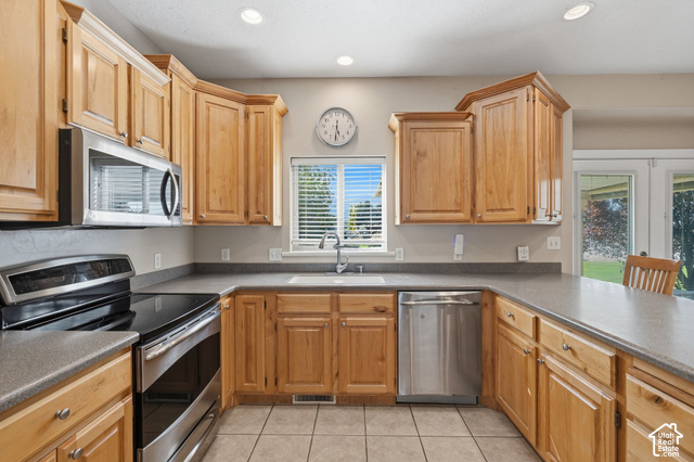 1447 Meadow Lane Mapleton, UT 84664 - Photo 15 of 67 Hardwood cabinetry, stainless steel appliances, recessed lighting, tile flooring, and a window above the sink