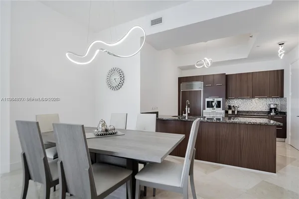 a kitchen with granite countertop stainless steel appliances and cabinets
