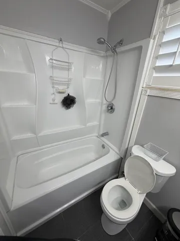 a bathroom with a toilet and a shower