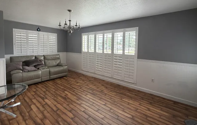 a living room with furniture and a chandelier