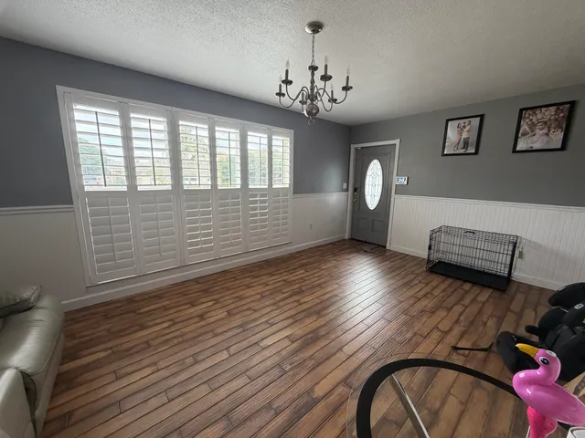 a view of livingroom with furniture wooden floor and a chandelier