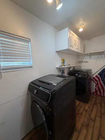 a kitchen with a stove sink and cabinets