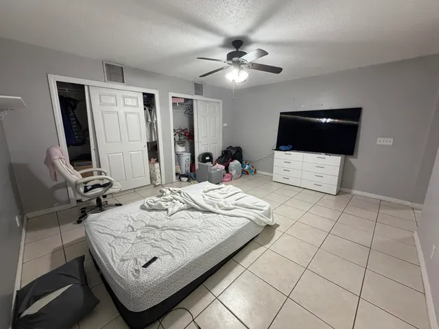 a bedroom with a bed a rug and wooden floor