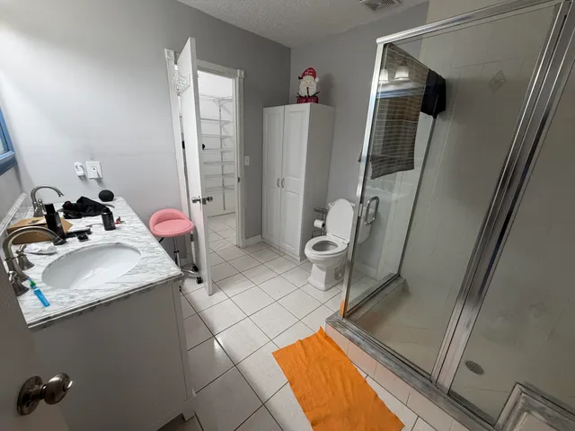 a bathroom with a sink toilet and shower