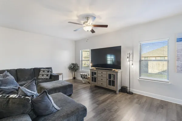 a living room with furniture and a flat screen tv