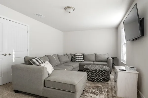 a living room with furniture and a flat screen tv