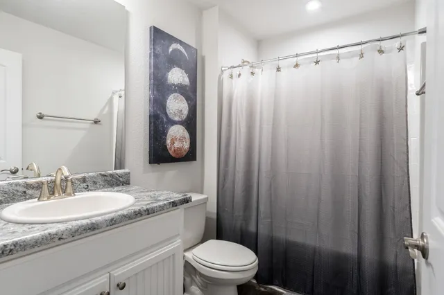 a bathroom with a sink toilet and shower
