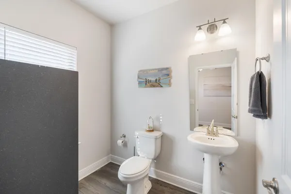 a white toilet sitting next to a bath tub