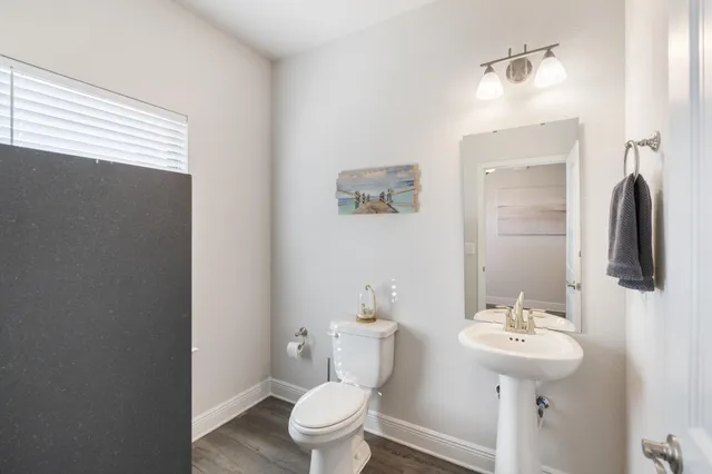 a white toilet sitting next to a bath tub