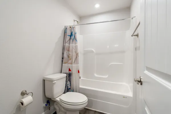 a view of a patio with chairs and potted plants