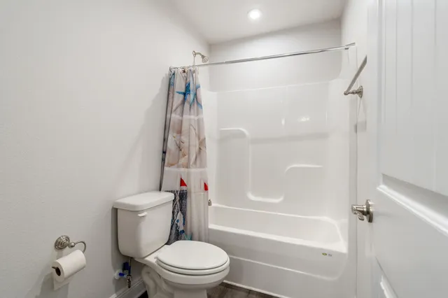 a view of a patio with chairs and potted plants