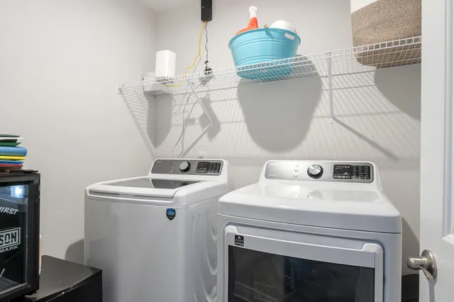 a view of a porch with furniture and a yard