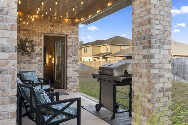 a front view of house with outdoor seating and yard