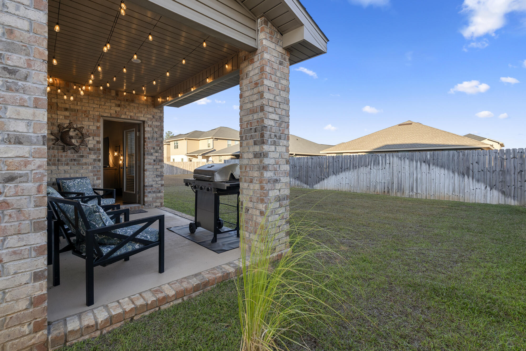 113 Ridgeway Circle Crestview, FL 32536 - Photo 47 of 54 a view of a patio with chairs and potted plants