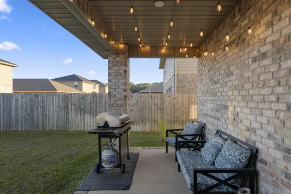 a swimming pool with outdoor seating and yard