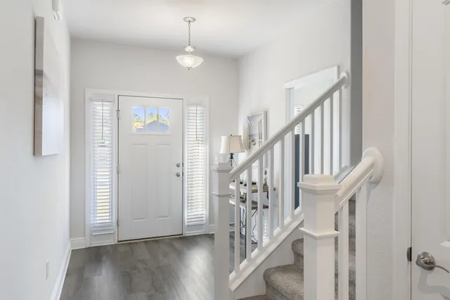 a kitchen with a sink stove cabinets and refrigerator