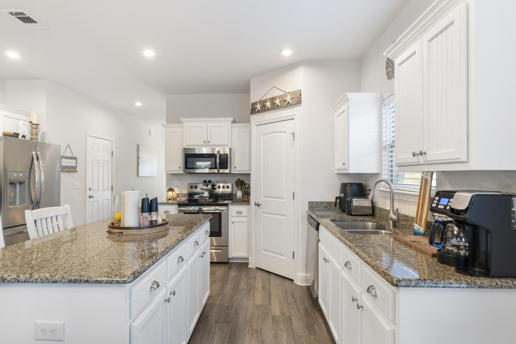 113 Ridgeway Circle Crestview, FL 32536 - Photo 10 of 54 a kitchen with stainless steel appliances granite countertop a sink stove refrigerator and cabinets