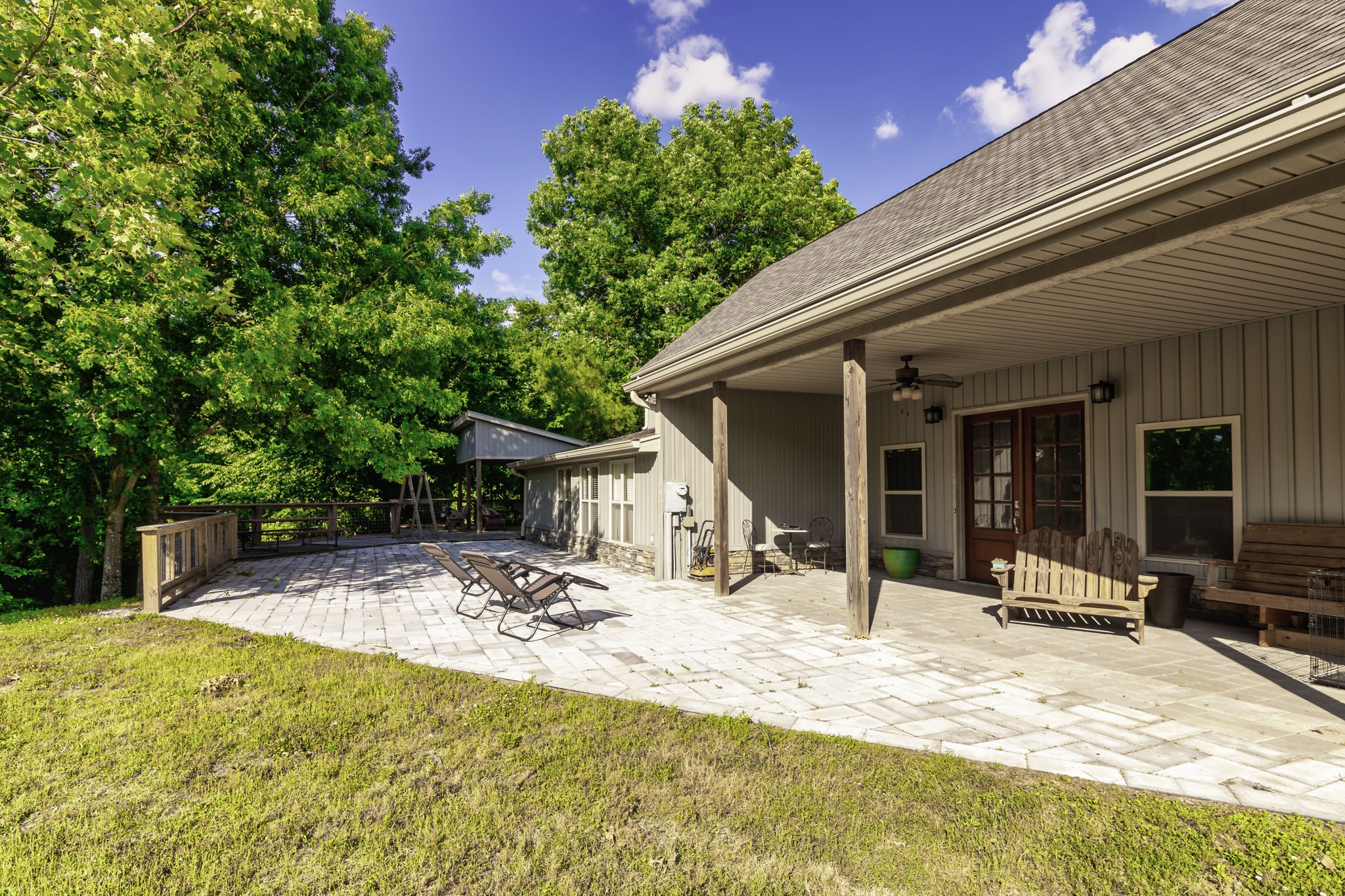 a swimming pool with outdoor seating and yard