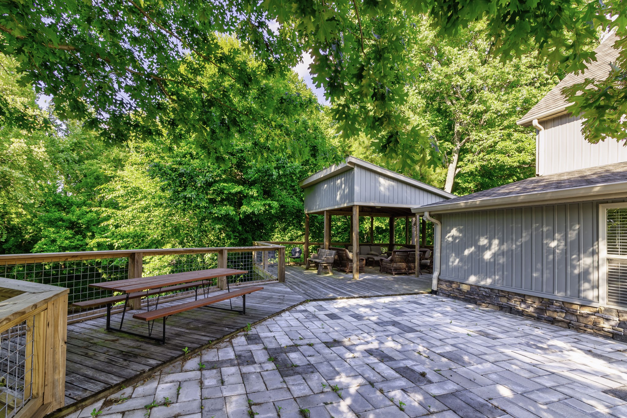 82 Railroad Road Westpoint, TN 38486 - Photo 19 of 30 a backyard of a house with table and chairs under an umbrella