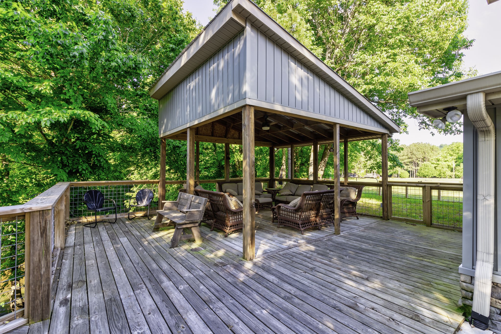 82 Railroad Road Westpoint, TN 38486 - Photo 20 of 30 a patio with wooden floor a yard tables and chairs