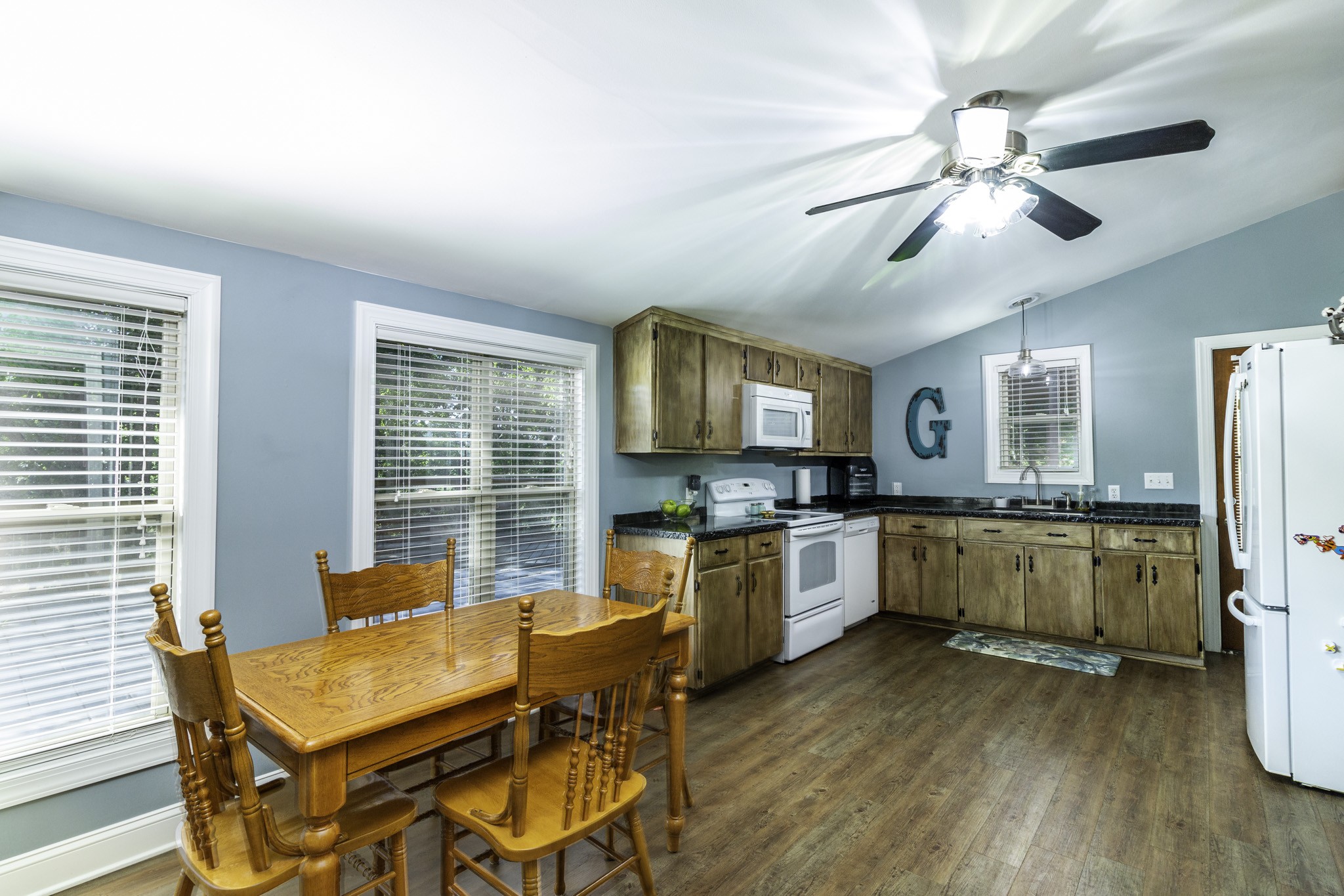82 Railroad Road Westpoint, TN 38486 - Photo 7 of 30 a kitchen with a table chairs refrigerator and microwave