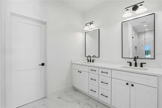 a bathroom with double sink and a mirror