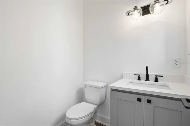 a bathroom with a sink a toilet and mirror