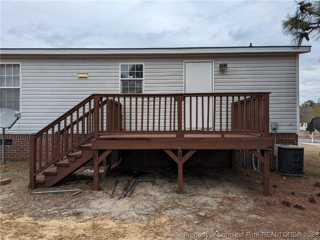 271 Eisler Drive Lillington, NC 27546 - Photo 3 of 17 a backyard of a house with a wooden deck and furniture