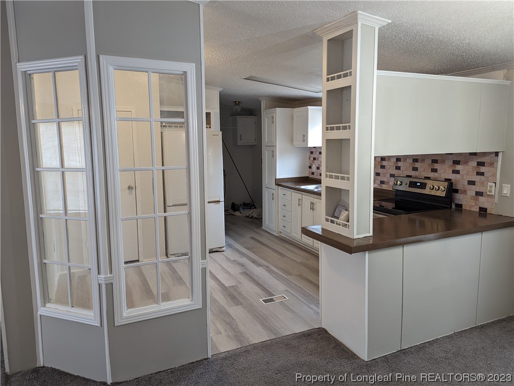 271 Eisler Drive Lillington, NC 27546 - Photo 5 of 17 a kitchen with white cabinets and counter space