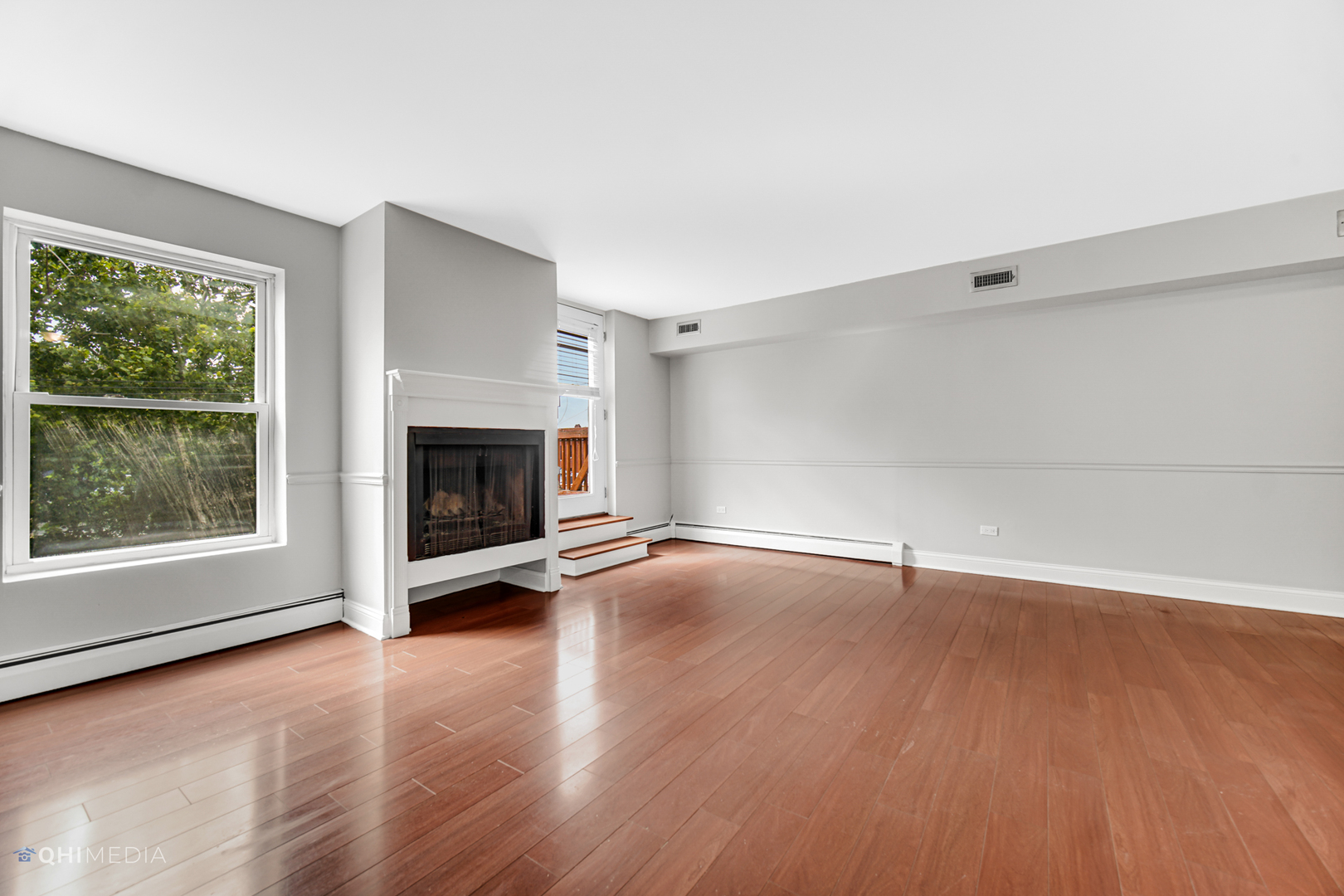 1750 North Wells Street, Unit 403 Chicago, IL 60614 - Photo 16 of 20 an empty room with wooden floor fireplace and windows