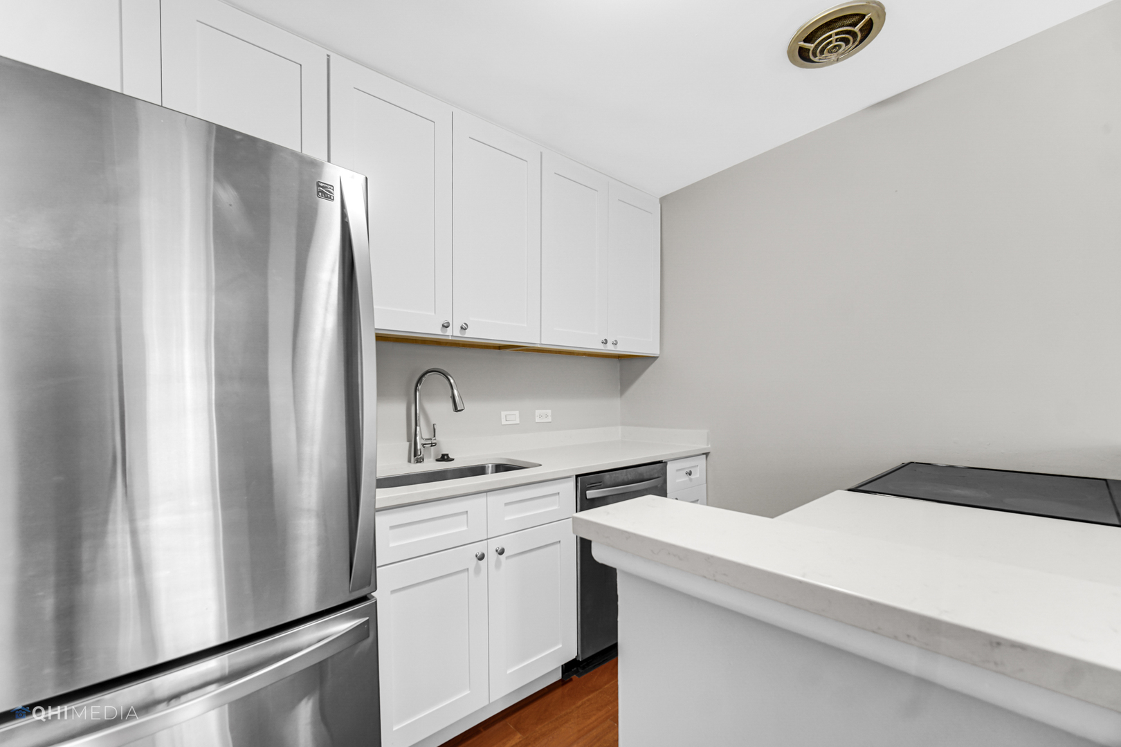 1750 North Wells Street, Unit 403 Chicago, IL 60614 - Photo 7 of 20 a kitchen with appliances a refrigerator and cabinets