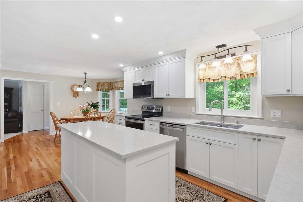 9 Fazio Farm Road Georgetown, MA 01833 - Photo 9 of 42 a kitchen with a sink a stove a refrigerator and white cabinets