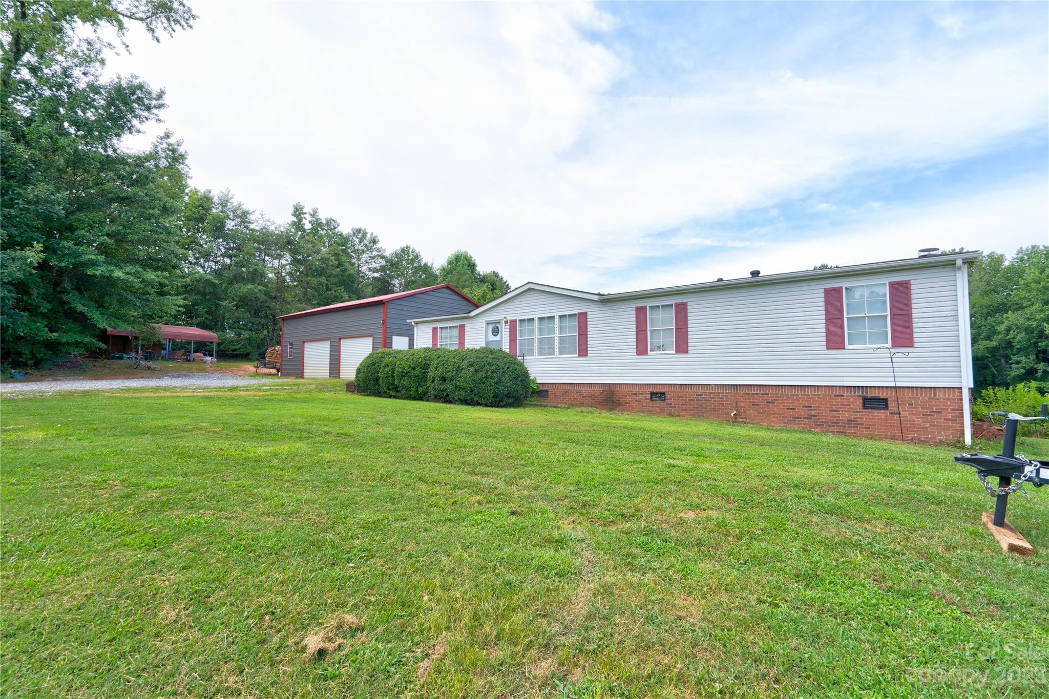 389 Shires Road Ellenboro, NC 28040 - Photo 2 of 30 a house view with a garden space