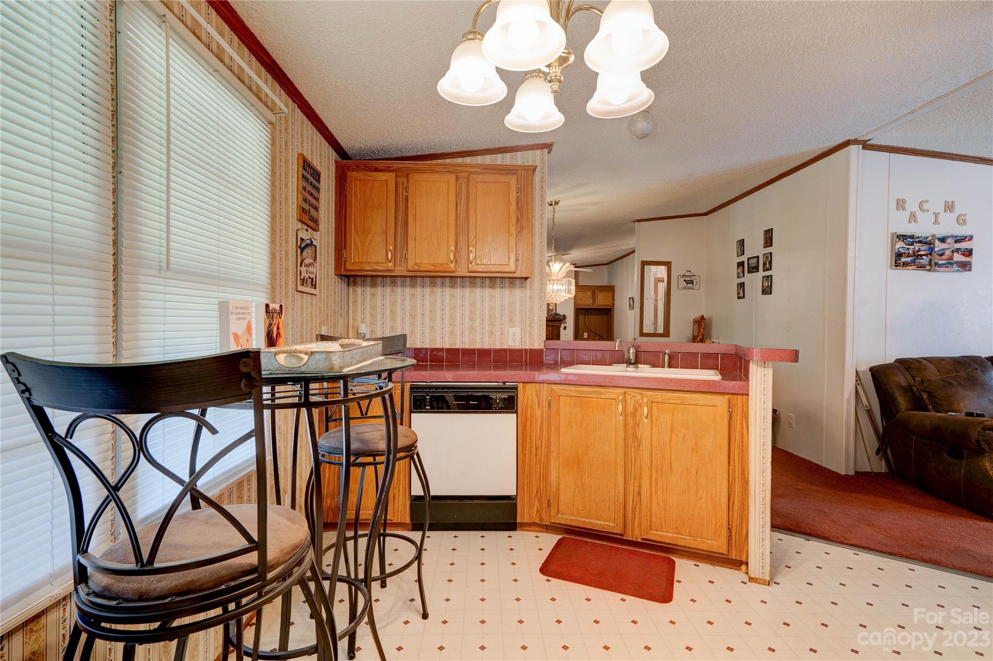389 Shires Road Ellenboro, NC 28040 - Photo 24 of 30 a kitchen with stainless steel appliances kitchen island granite countertop a table chairs in it and wooden floors