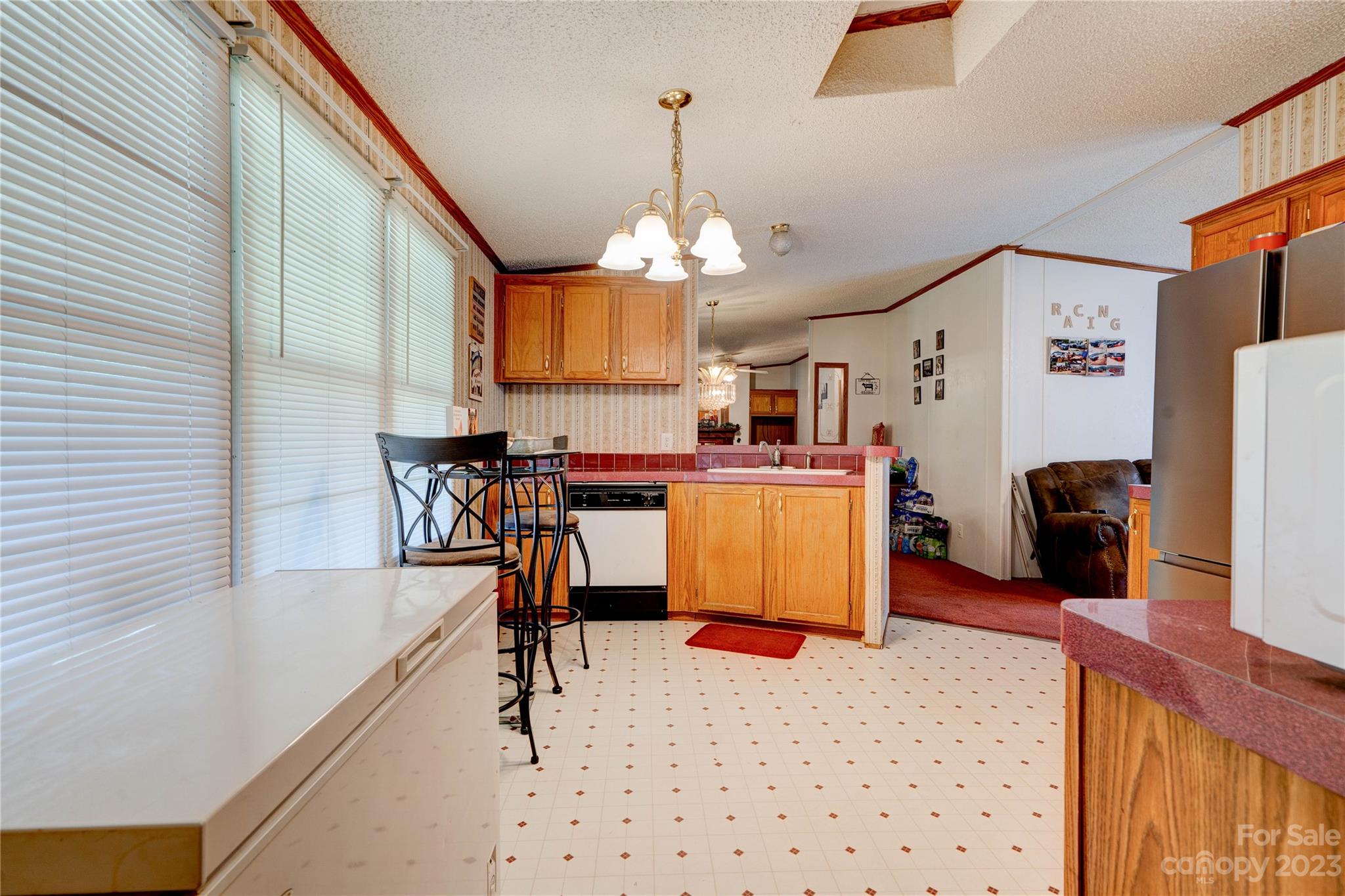 389 Shires Road Ellenboro, NC 28040 - Photo 26 of 30 a kitchen with a refrigerator a dining table and chairs